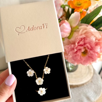 Collar de acero inoxidable dorado con flor de nácar en caja de regalo
